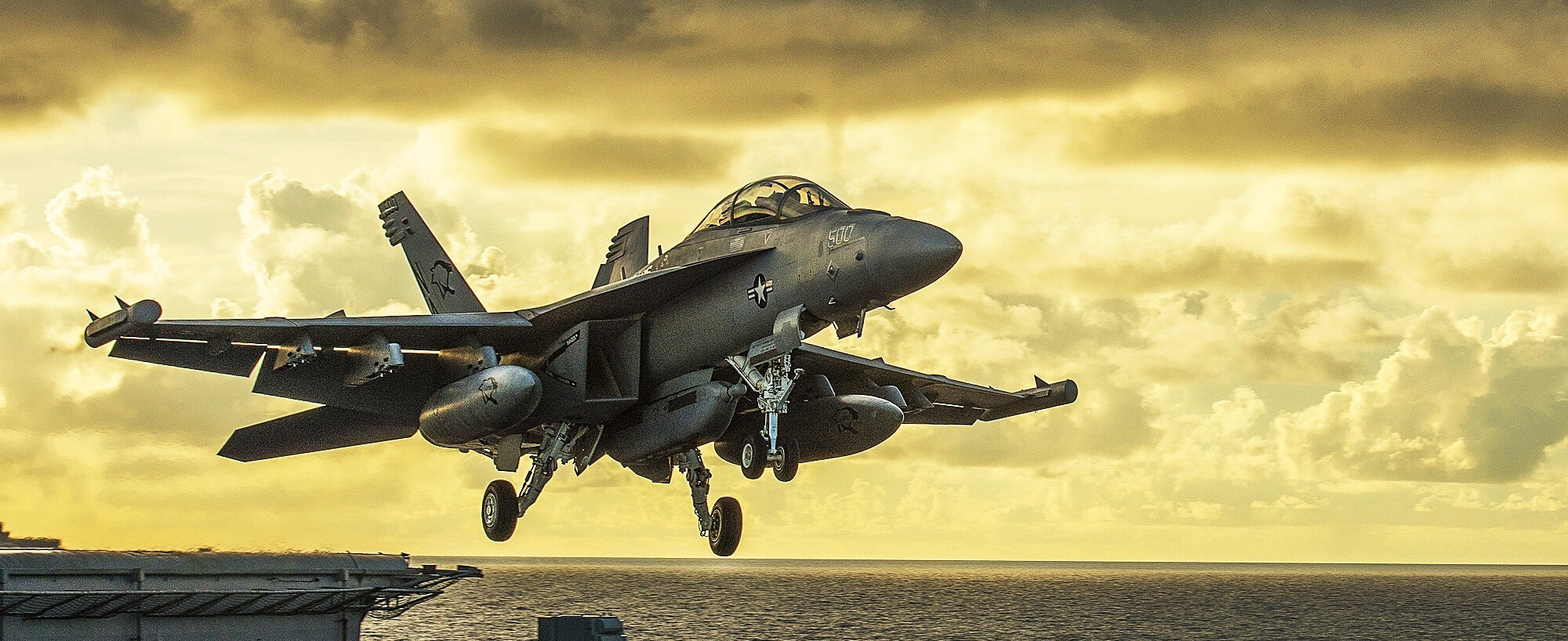 A fighter jet taking off from an aircraft carrier